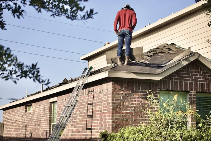 Professional roofer working on a residential roof in Maryknoll